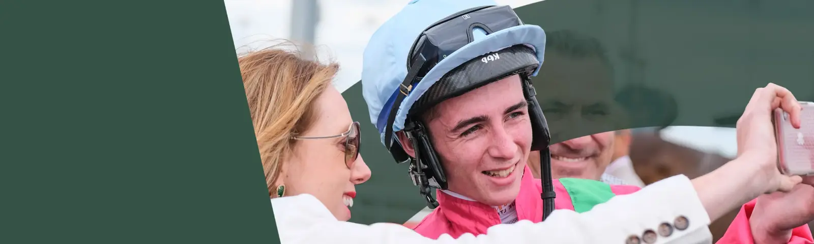 Jockey posing for a selfie with a fan.