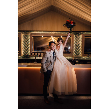 Newlywed couple smiling for a photo.
