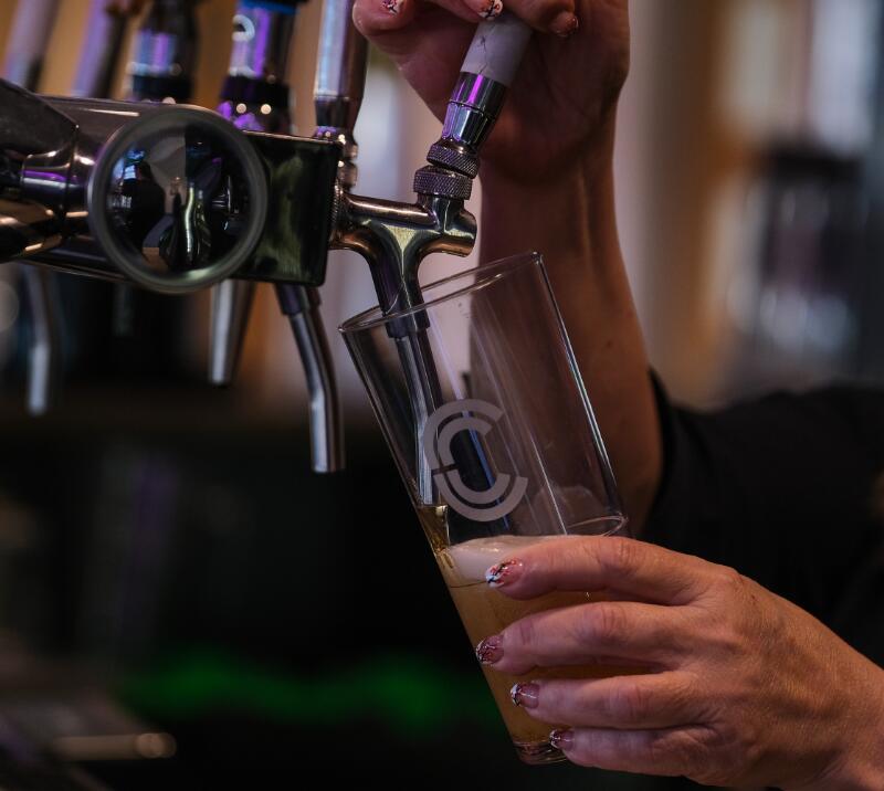Pint being poured in a bar.