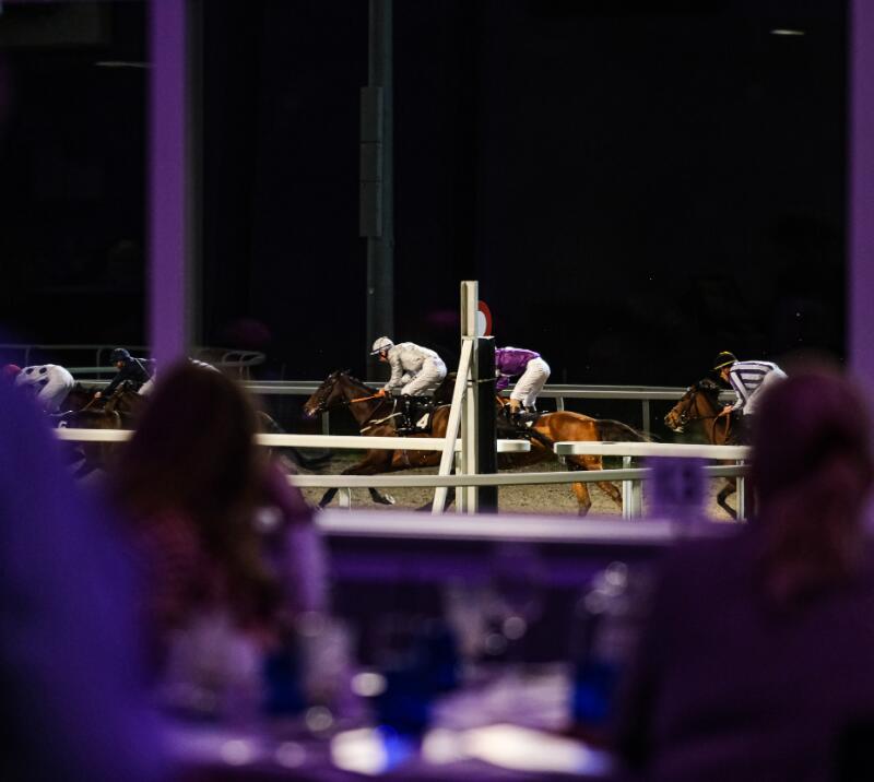 View of jockeys crossing the finish line.