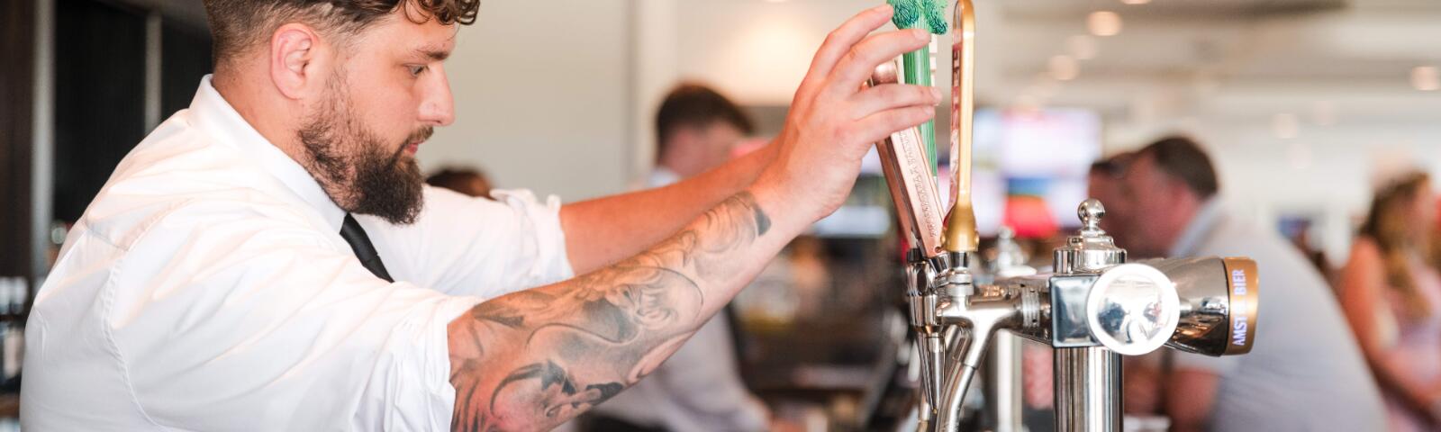 Barman pouring a pint.